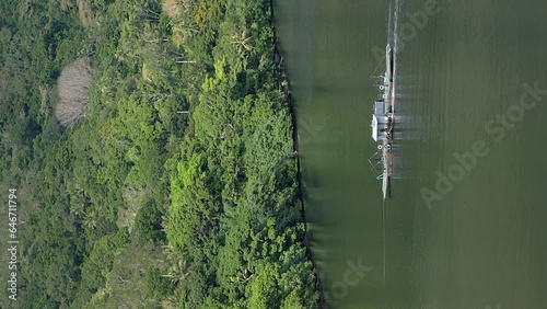 Passenger ferry crossing Ouaieme River. Hienghene, New Caledonia. Vertical video. photo