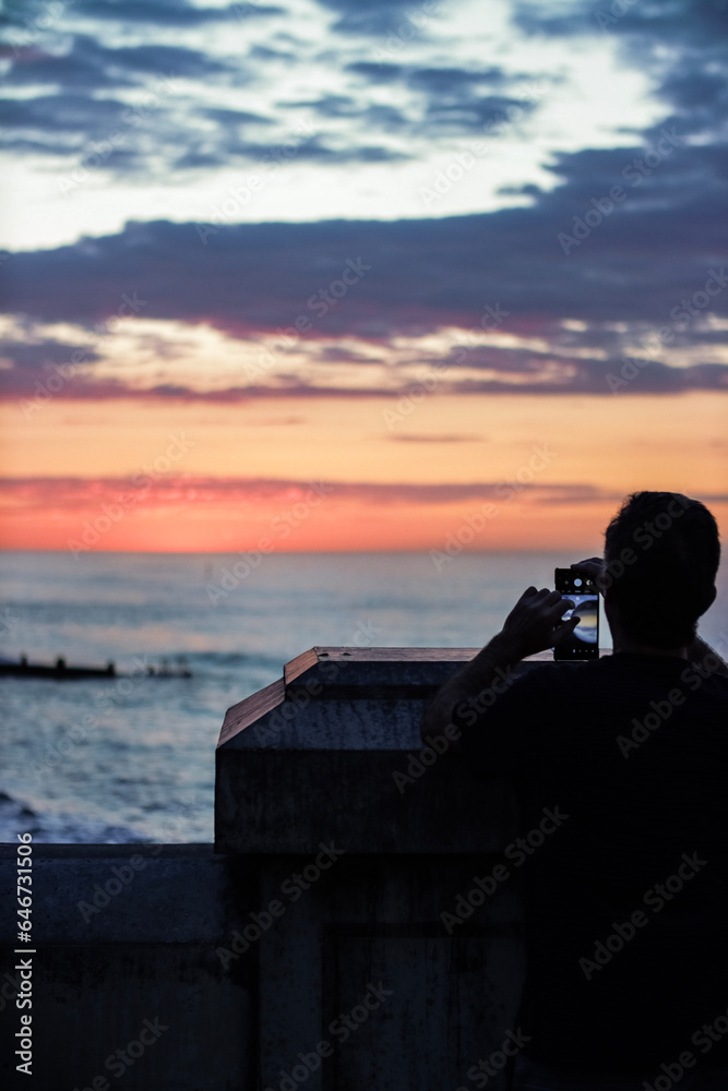 person watching sunset cromer 