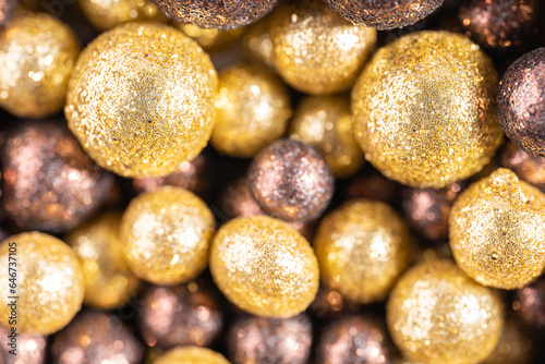 Colorful baubles decoration. Golden and brown glittering bubbles, macro. Balls textured with glittering paillettes. Event concept. Xmas background