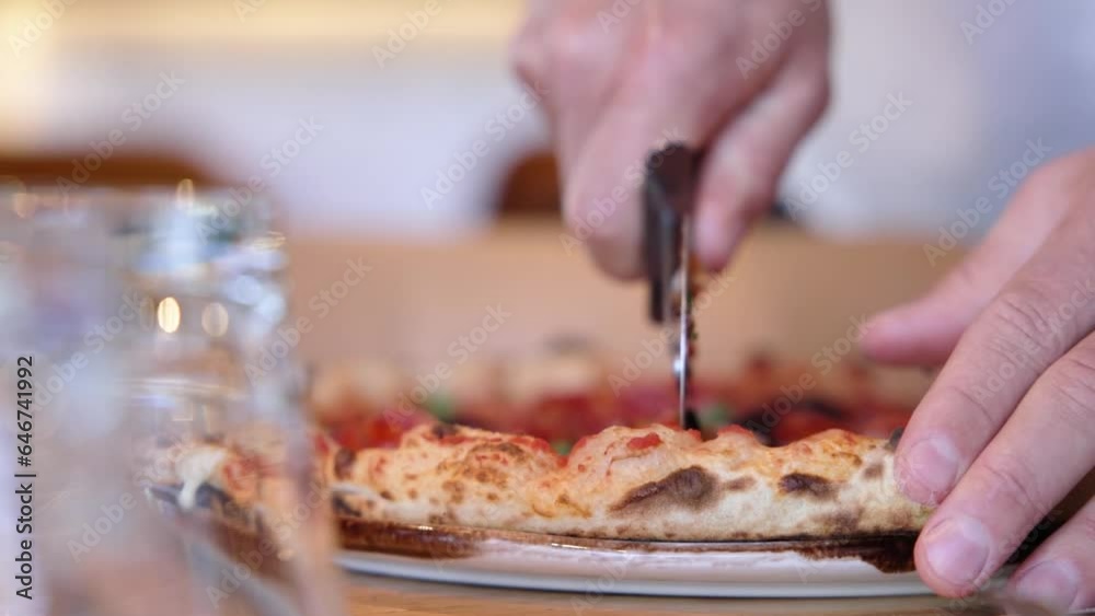 Close up of a person slicing a pizza slow motion Close up of a person slicing a pizza slow motion