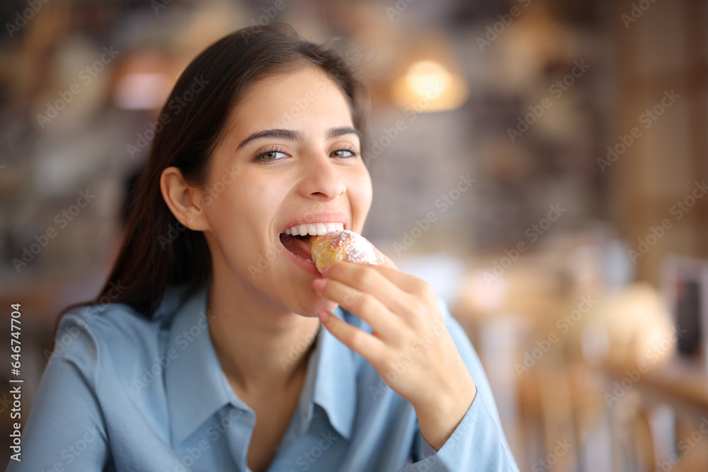 Happy bar customer looking at you eating croissant Happy bar customer looking at you eating croissant