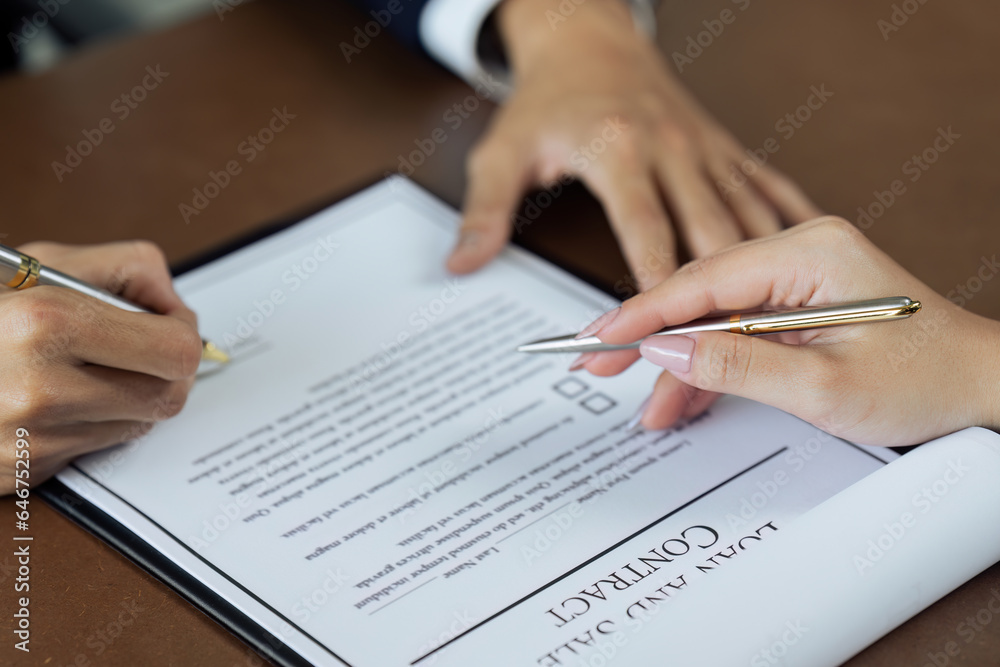 Close up image of businessman hand putting personal signature on contract document Close up image of businessman hand putting personal signature on contract document