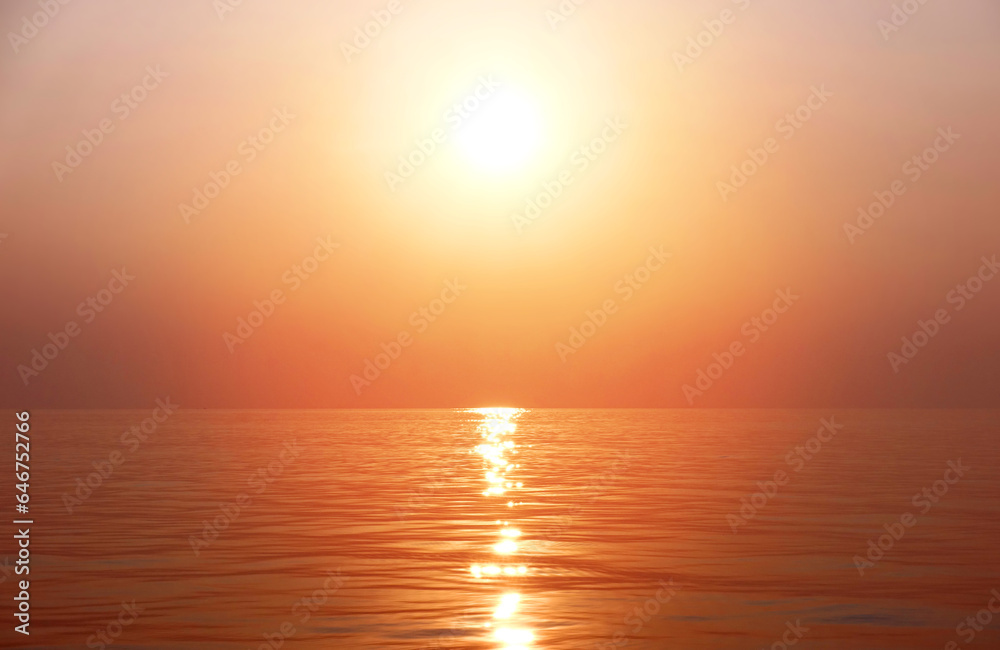 Background image of the ocean in summer time. Beautiful sunset sky over the sea at tropical beach in the evening with orange filter. Fantastic sunrise sky over surface water in the morning, copy space