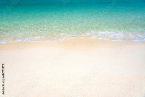 Fantastic golden sand beach with clear blue water. Summer outdoor nature holiday serenity. Beautiful clean sandy beach with soft blue ocean wave. Background  copy space or space for text.