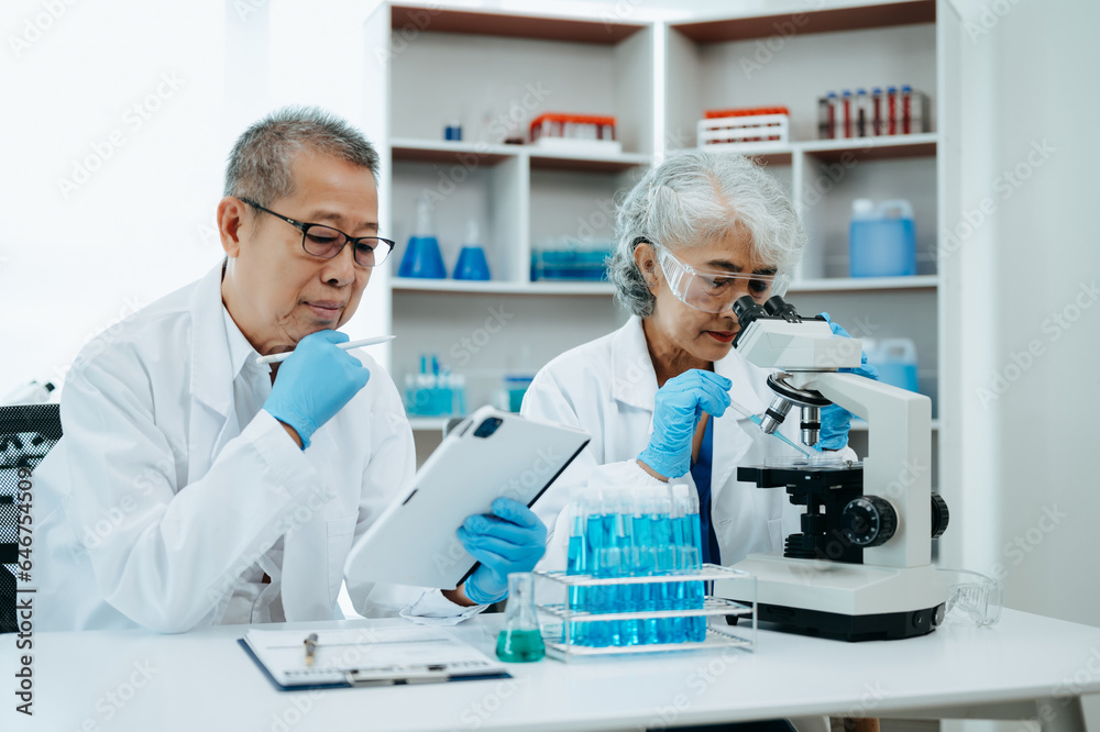 Asian senior Scientist team meeting and writing analysis results in the laboratory study and analyze scientific sample. Asian senior Scientist team meeting and writing analysis results in the laboratory study and analyze scientific sample.