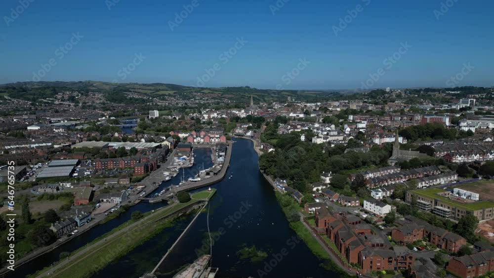 Exeter, South Devon, England: DRONE VIEWS: High angle view of the River Exe (centre), Exeter Ship Canal, Trews Weir, Exeter Quays and the city of Exeter, which is a popular UK tourist destination. Exeter, South Devon, England: DRONE VIEWS: High angle view of the River Exe (centre), Exeter Ship Canal, Trews Weir, Exeter Quays and the city of Exeter, which is a popular UK tourist destination.