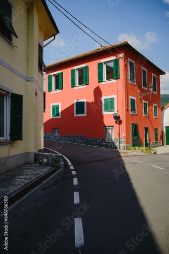 The shadow of the church on the facade of a typical red European house