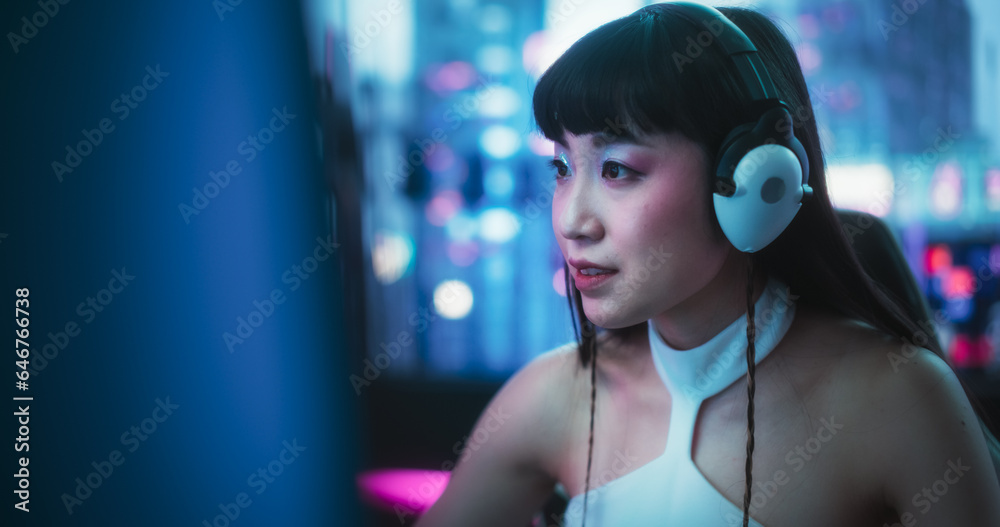 Helpful Japanese Female Having a Conversation on a Video Call, While Sitting Behind a Desk, Using Computer in a Futuristic Technological Office Space. Young Female Manager Working in Tech Support