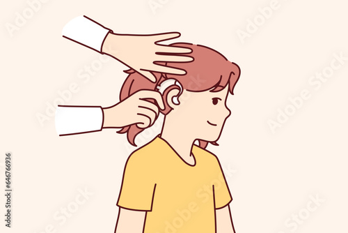 Doctor puts hearing aid on child ear to help girl cope with congenital problem that causes deafness. Hearing aid for people with sound perception disorder caused by trauma or congenital disease