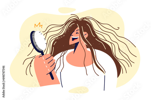 Shaggy woman is holding comb and laughing, seeing electrified hair sticking out in directions