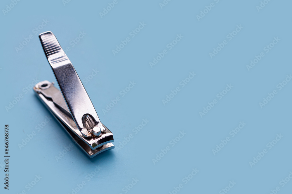 Nail clippers on blue background. Nail clippers on blue background.