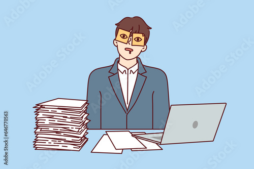 Man office worker is sleeping at workplace with sticky stickers on eyes and sitting at table with papers and computer. Guy is tired of paperwork and bureaucratic procedures sleeping