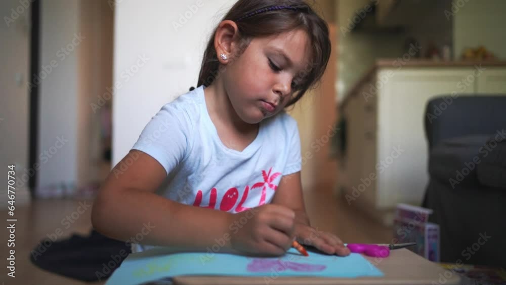 Close-up of child hand drawing with crayons or wax pastel at home. Crafting, drawing, developing creativity and motor skills 