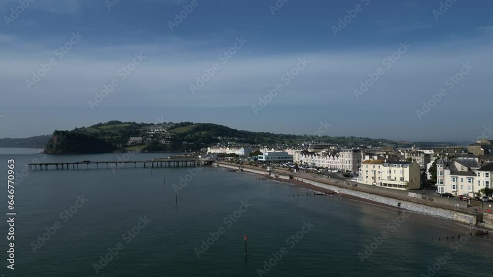 Teignmouth, South Devon, England: DRONE VIEWS: Teignmouth Pier, the Ness escarpment, Teignmouth seafront and the Pavilions (cinema). Teignmouth is a popular UK holiday resort. Teignmouth, South Devon, England: DRONE VIEWS: Teignmouth Pier, the Ness escarpment, Teignmouth seafront and the Pavilions (cinema). Teignmouth is a popular UK holiday resort.