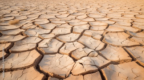 Close-up of cracked, sun-baked desert ground with intricate patterns. Barren and dry soil, weathered by aridity and erosion. Abstract texture of a desolate, drought-stricken landscape.