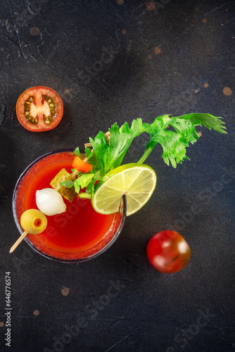 Bloody Mary cocktail with garnish on a black background, shot from above with copy space. Spicy tomato juice with alcohol