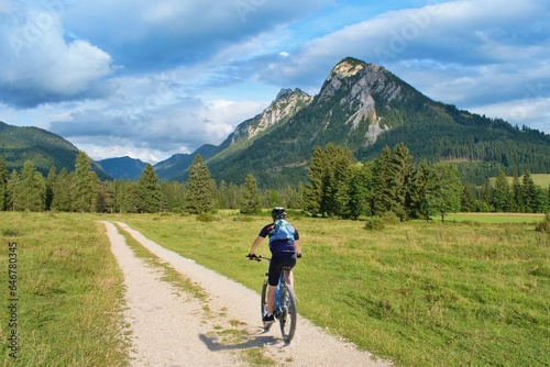 Biker riding scenic path in beautiful summer mountain scenery , European Alps, Austria