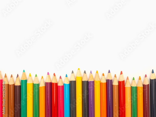 Colorful colored pencils on a white background in a creative workspace.