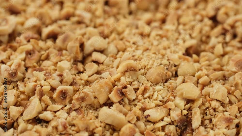 Zoom frame ground roasted hazelnuts close up falling down, rotation Zoom frame ground roasted hazelnuts close up falling down, rotation