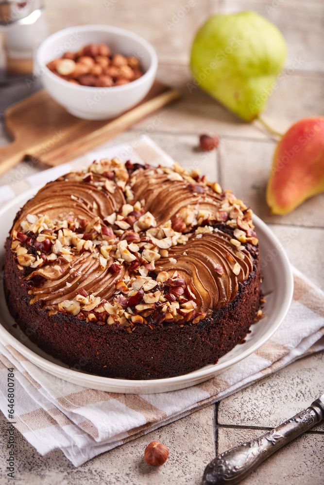 Chocolate sponge cake with pears and hazelnuts. Delicious autumn homemade sweet pie with seasonal fruits. Chocolate sponge cake with pears and hazelnuts. Delicious autumn homemade sweet pie with seasonal fruits.