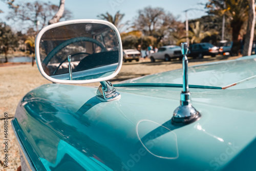 Car rear view mirror of an antique vehicle. Classic vintage style.