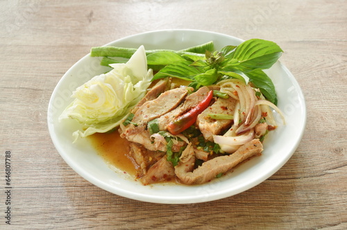 Thai spicy slice boiled pork neck salad eat couple fresh cabbage and yard long bean on plate 