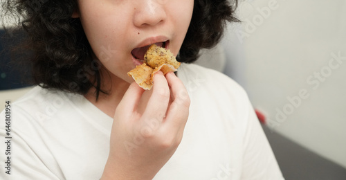 girl hold and eating muffins   close up mouth chewing