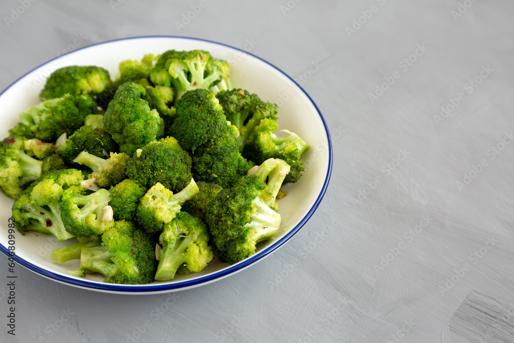 Homemade Pan-fried Broccoli on a Plate on a gray background, side view. Copy space. Homemade Pan-fried Broccoli on a Plate on a gray background, side view. Copy space.