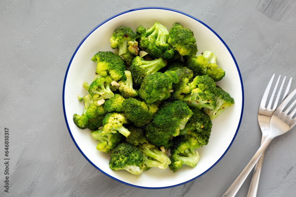 Homemade Pan-fried Broccoli on a Plate on a gray background, top view. Homemade Pan-fried Broccoli on a Plate on a gray background, top view.