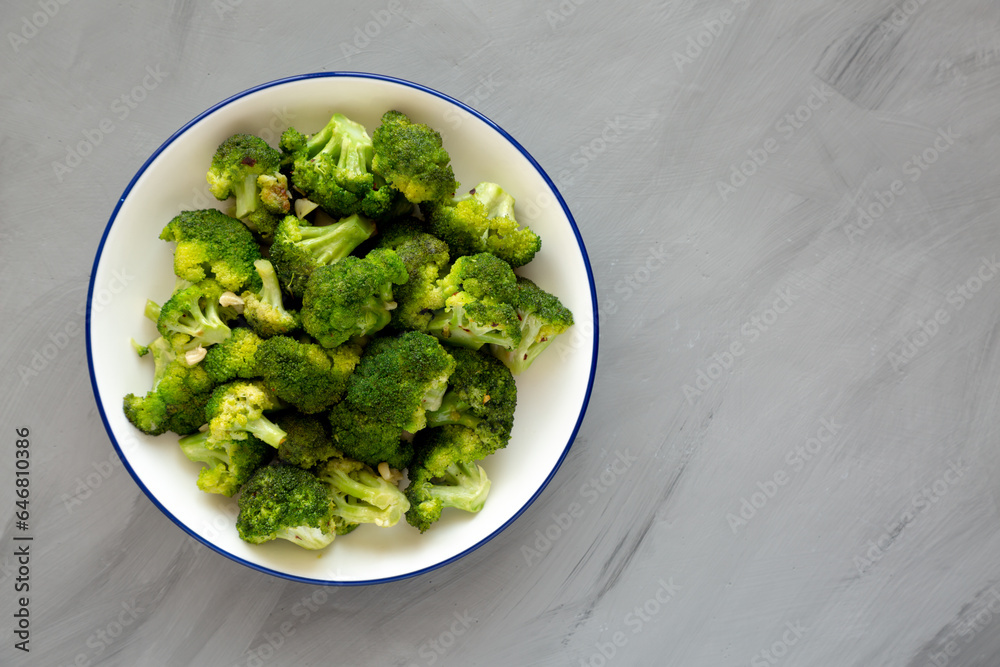 Homemade Pan-fried Broccoli on a Plate on a gray background, top view. Copy space. Homemade Pan-fried Broccoli on a Plate on a gray background, top view. Copy space.
