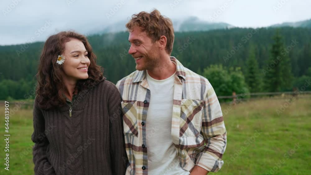 Lovely couple in love talking and walking on mountain in the woods Lovely couple in love talking and walking on mountain in the woods