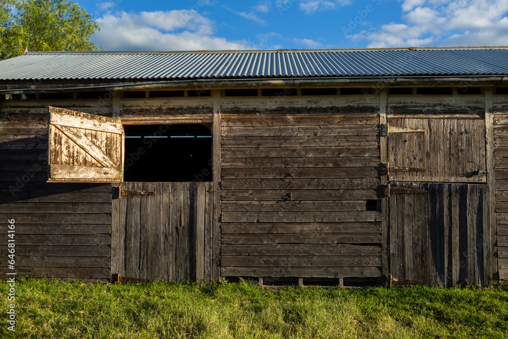 Old weather worn structure of wooden stables on farm in sunlight Stock ...
