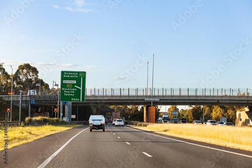 overpass bridge over road with cars driving on divided highway