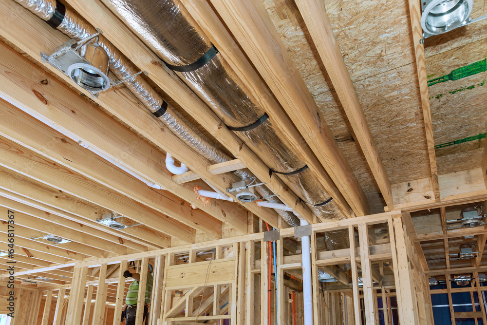 Installing central HVAC system puts spotlight on wooden beamed ceiling in new home. Installing central HVAC system puts spotlight on wooden beamed ceiling in new home.
