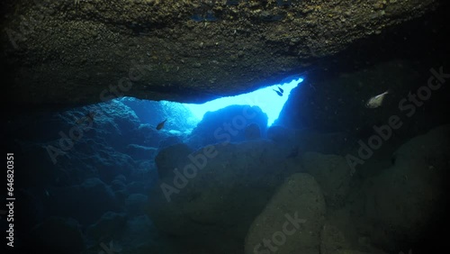 sun ray and sun beam scenery underwater cave divig with some fish photo