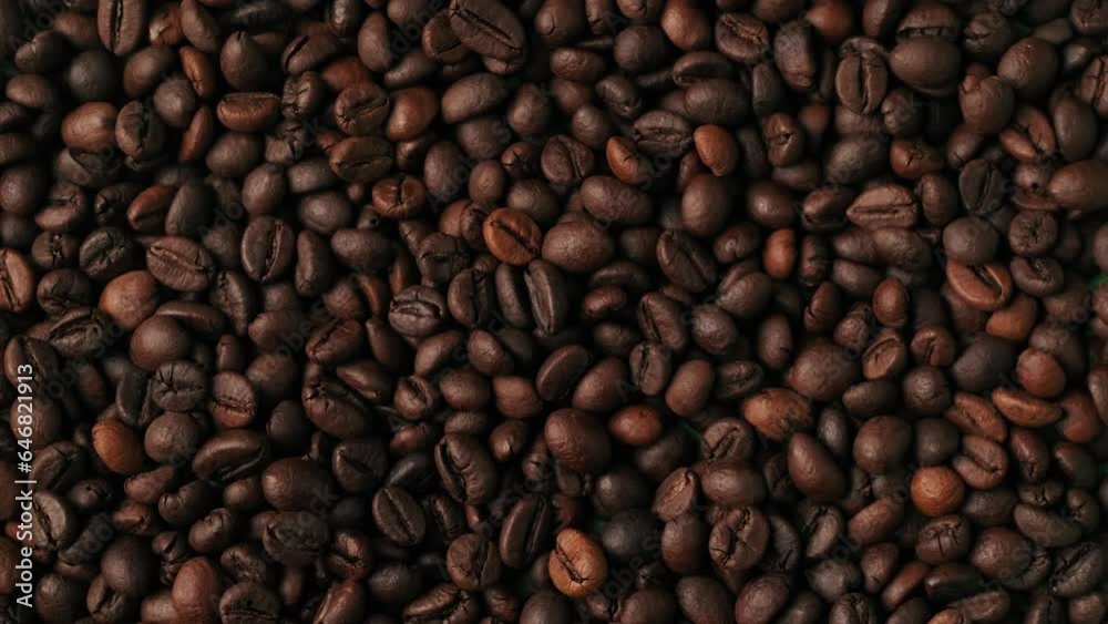 Closeup shot of small hole blown by the wind inside the many brown coffee beans on green background. Chroma Key. Closeup shot of small hole blown by the wind inside the many brown coffee beans on green background. Chroma Key.