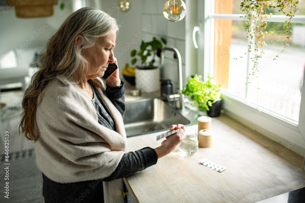 Senior woman using the smartphone to call and ask for advice on medication at home Senior woman using the smartphone to call and ask for advice on medication at home