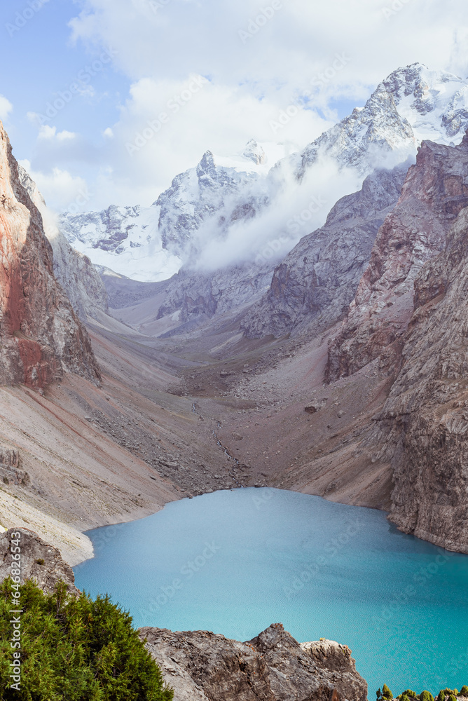 Mountain lake with azure water and snowy peaks in the heart of Tajikistan