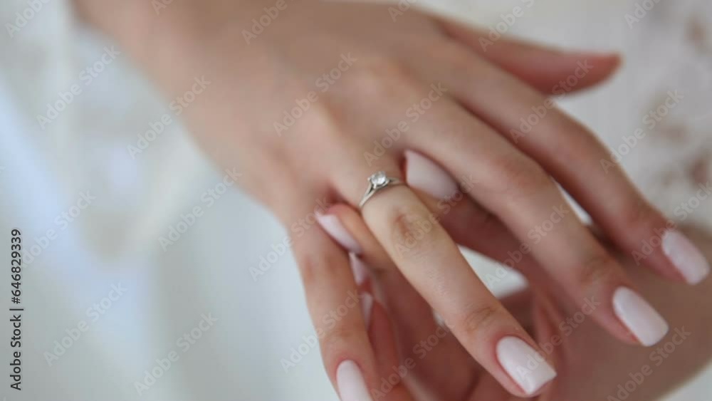 A bride with a white manicure puts a wedding ring on her ring finger. Morning of the bride. Wedding day. A bride with a white manicure puts a wedding ring on her ring finger. Morning of the bride. Wedding day.