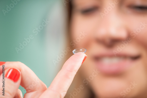 Fotografie Skilled ophthalmologist precisely inserts soft contact lens for enhanced vision