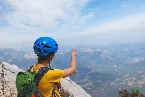 adventure in the mountains. girl with a backpack in the high mountains. Rock climbing and mountaineering concept.