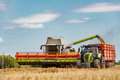 Agriculture field with heavy machinery ready to hrvest during harvesting season in the end of summer