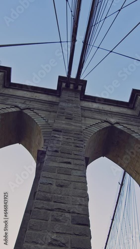 NYC, Brooklyn bridge against blue sky, low angle view, vertical short video