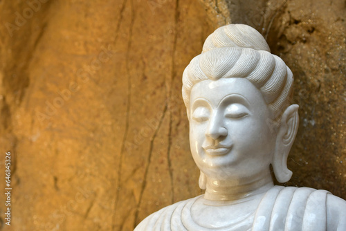 The face of a white stone Buddha