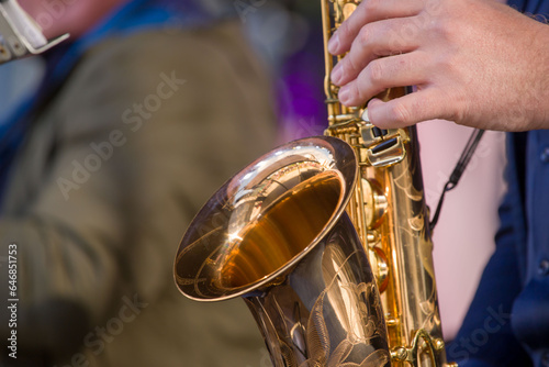 street musician playing the saxophone on a bright sunny day