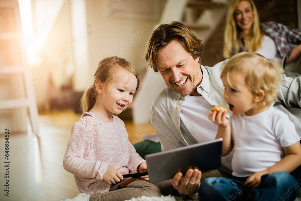 Young family using a tablet and playing at home Young family using a tablet and playing at home