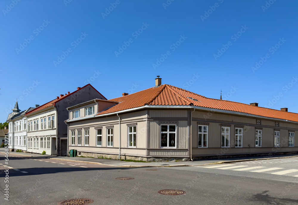Happy walking in old Fredrikstad on a great warm summer day, with many old buildings, Norway