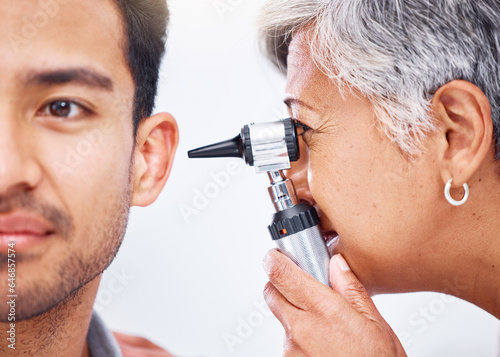 Hearing test, doctor and patient with healthcare consultation closeup, face and ENT specialist with otoscope. Medical professional, assessment and trust with man and senior woman with ear check