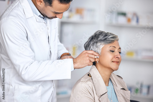 Hearing aid, medical and consulting with doctor and woman with a disability for healthcare, technology and sound waves. Medicine, wellness and audio with people and cochlear implant for treatment photo