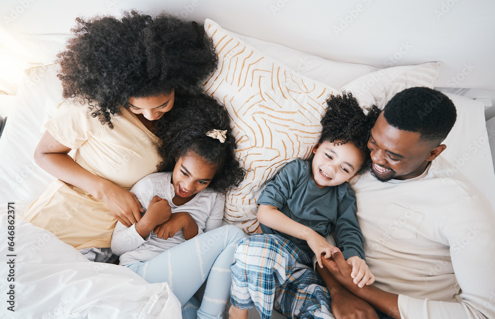 Mom, father and kids in bed with tickling, comic joke and laugh in top view, care and love in family house. Black man, mother and daughter with smile, play game and crazy in bedroom, morning and home